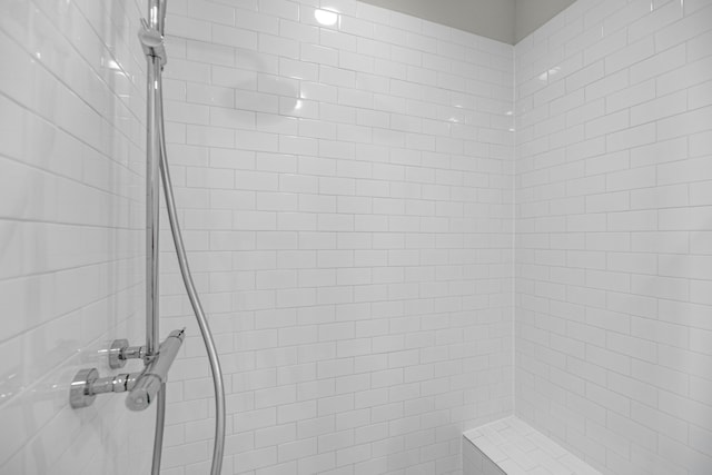 bathroom with tiled shower