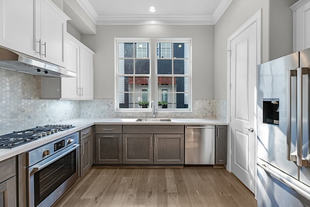 kitchen featuring light wood-type flooring, white cabinetry, sink, and stainless steel appliances