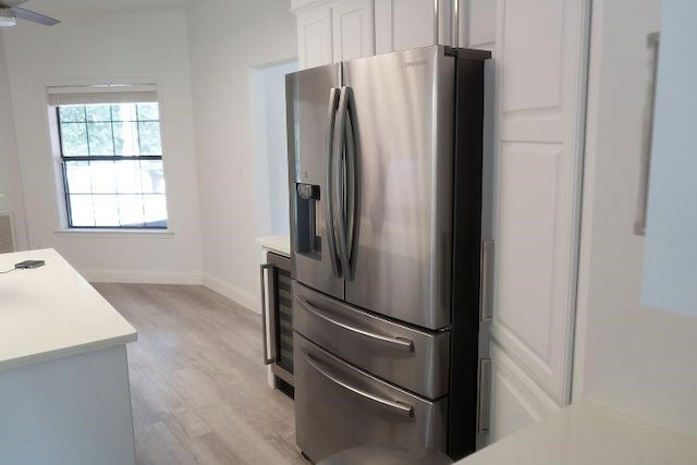 kitchen featuring white cabinetry, wine cooler, ceiling fan, light hardwood / wood-style flooring, and stainless steel fridge with ice dispenser