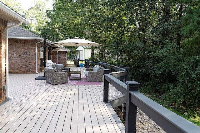 wooden terrace with an outdoor living space