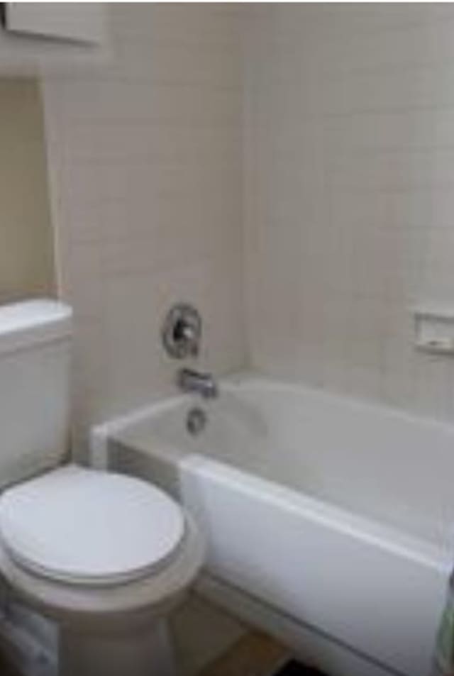 bathroom featuring toilet and shower / bathing tub combination