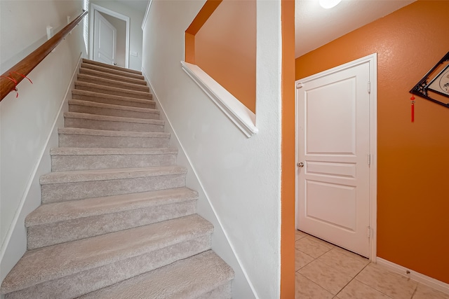 staircase with tile patterned floors