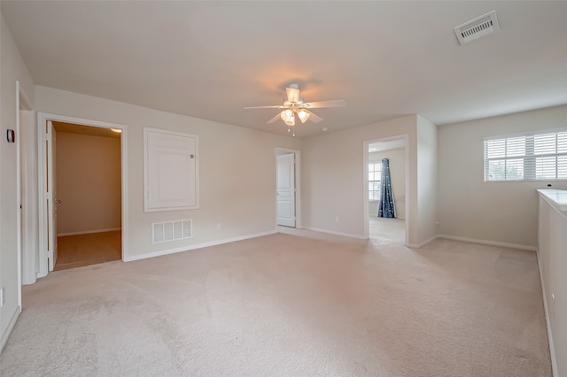 carpeted empty room featuring ceiling fan