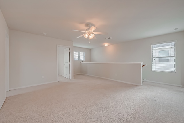 carpeted empty room featuring ceiling fan