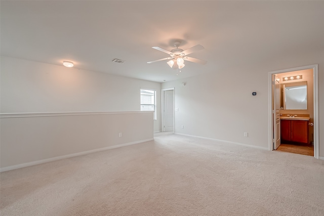 carpeted empty room with ceiling fan and sink