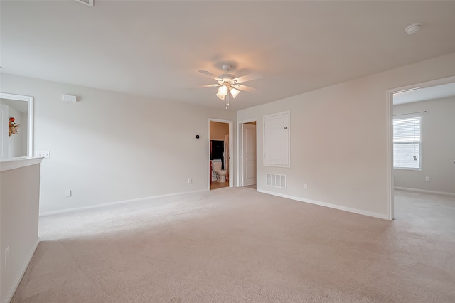 empty room featuring ceiling fan and light colored carpet