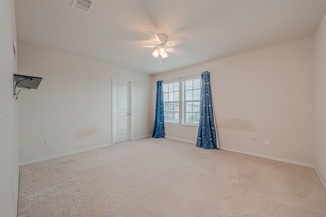 carpeted spare room with ceiling fan