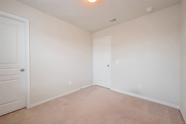 unfurnished room featuring light colored carpet