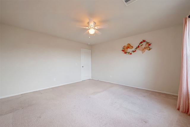 empty room with ceiling fan and carpet