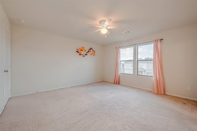 carpeted spare room with ceiling fan