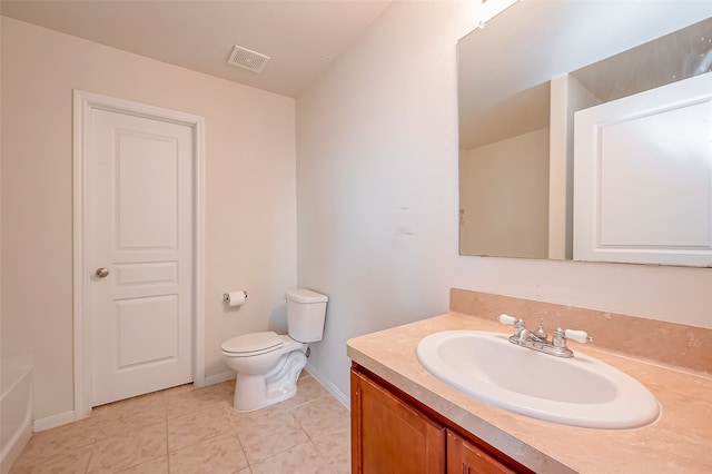 bathroom featuring vanity, tile patterned flooring, and toilet