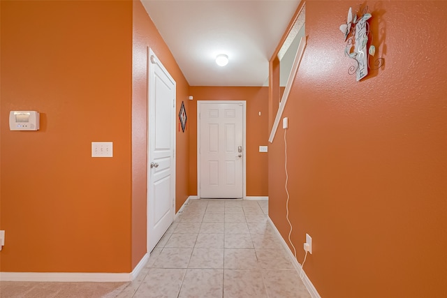 hall with light tile patterned flooring