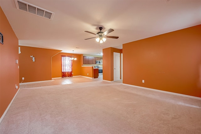 spare room with ceiling fan with notable chandelier and light carpet