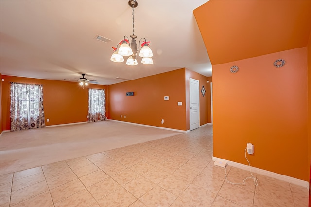 carpeted empty room with ceiling fan with notable chandelier