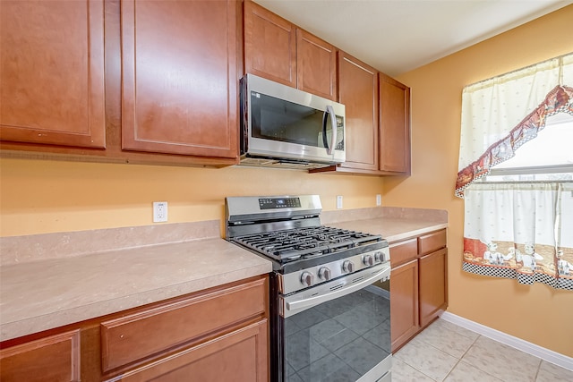 kitchen featuring appliances with stainless steel finishes and light tile patterned floors