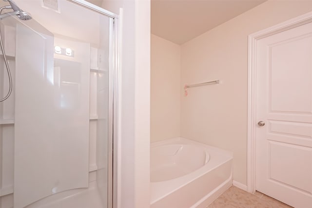 bathroom featuring plus walk in shower and tile patterned floors