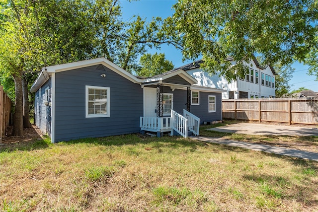 rear view of property with a yard and a patio