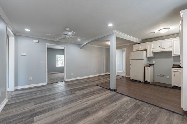 kitchen featuring white cabinetry, dark hardwood / wood-style floors, ceiling fan, and white refrigerator