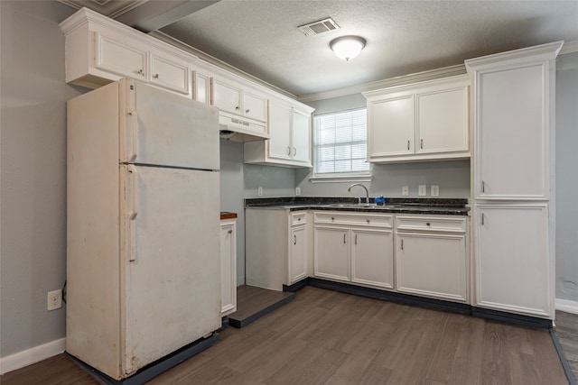 kitchen featuring dark hardwood / wood-style floors, sink, white cabinetry, white fridge, and crown molding