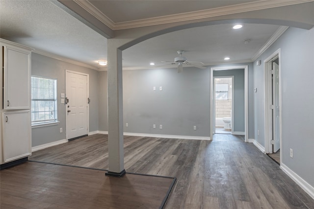 entryway featuring ornamental molding, ceiling fan, and dark hardwood / wood-style flooring