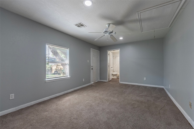 carpeted spare room with a textured ceiling and ceiling fan