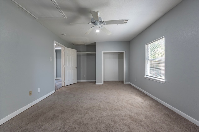 unfurnished bedroom with ceiling fan and carpet flooring