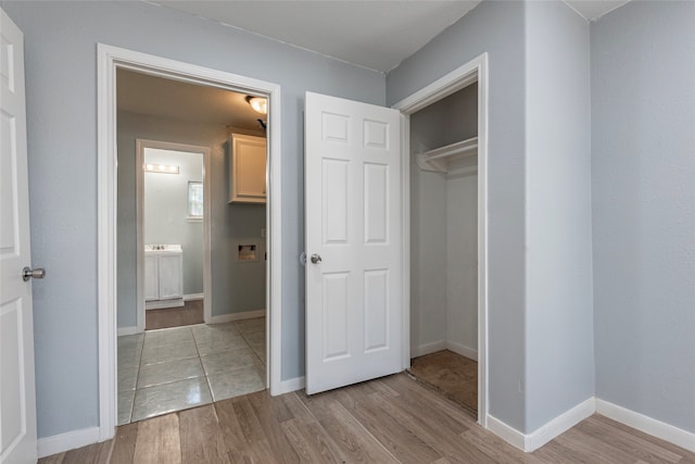 interior space with light wood-type flooring and a closet