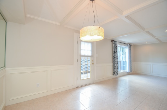 empty room with beamed ceiling, coffered ceiling, crown molding, and light tile patterned floors