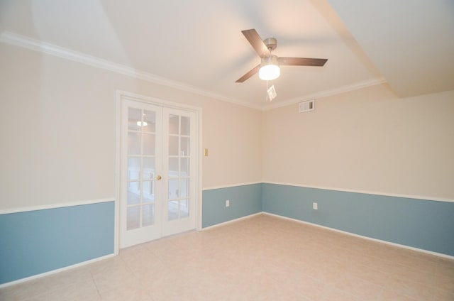 spare room with baseboards, visible vents, a ceiling fan, crown molding, and french doors