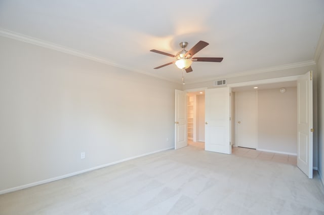 unfurnished bedroom with crown molding, ceiling fan, and light carpet