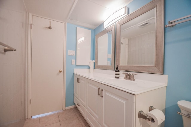 bathroom featuring tile patterned flooring, visible vents, vanity, and toilet