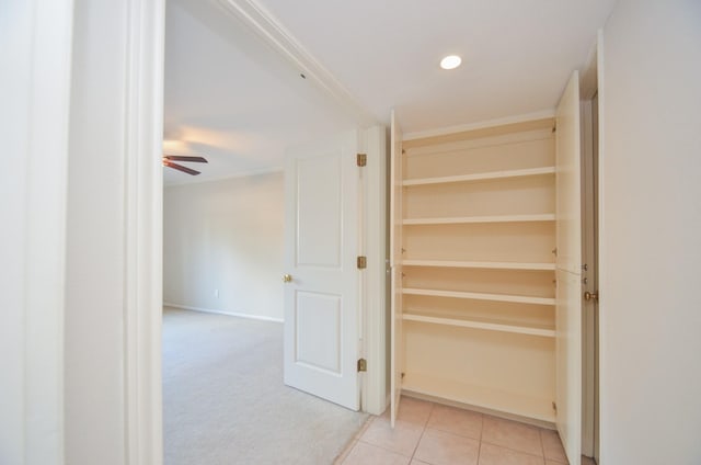 hall featuring light tile patterned floors and recessed lighting