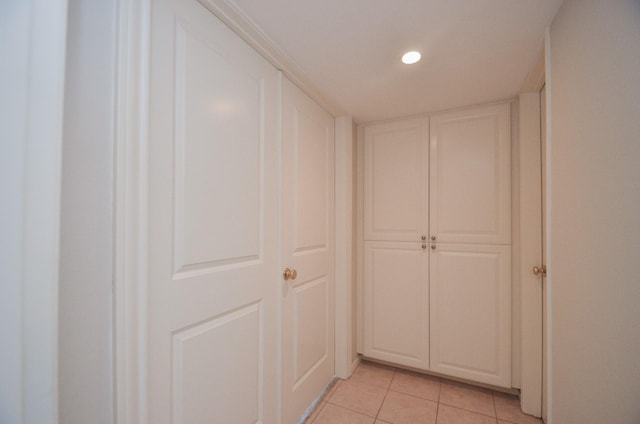 hall with recessed lighting and light tile patterned flooring