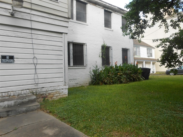 view of property exterior featuring a lawn