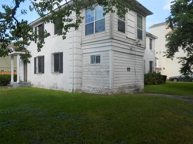 view of side of property with a yard