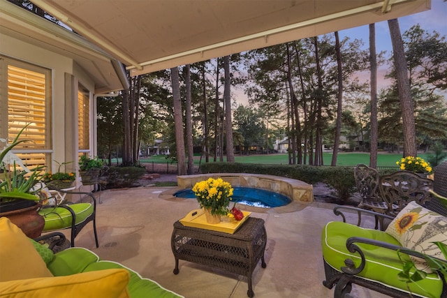 patio terrace at dusk featuring an in ground hot tub