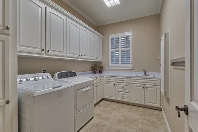 clothes washing area featuring light tile patterned floors, sink, cabinets, crown molding, and washer and dryer