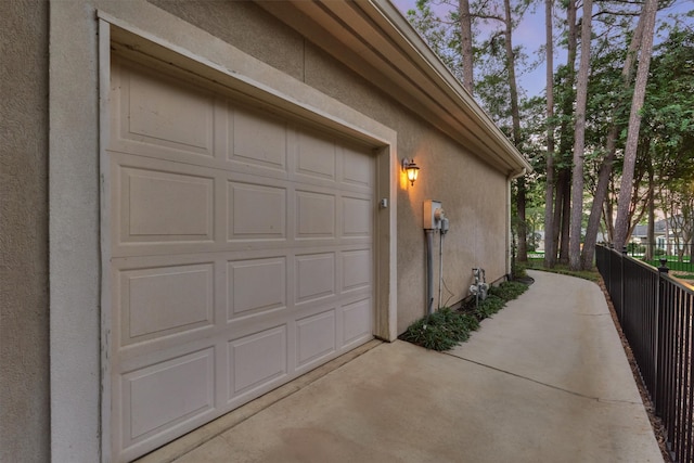 view of garage at dusk