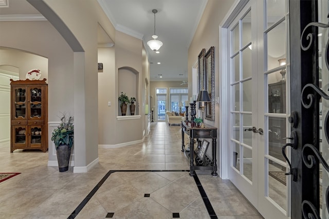 tiled entryway with french doors and ornamental molding