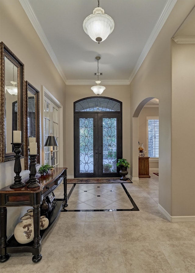 entrance foyer with light tile patterned floors, french doors, and crown molding