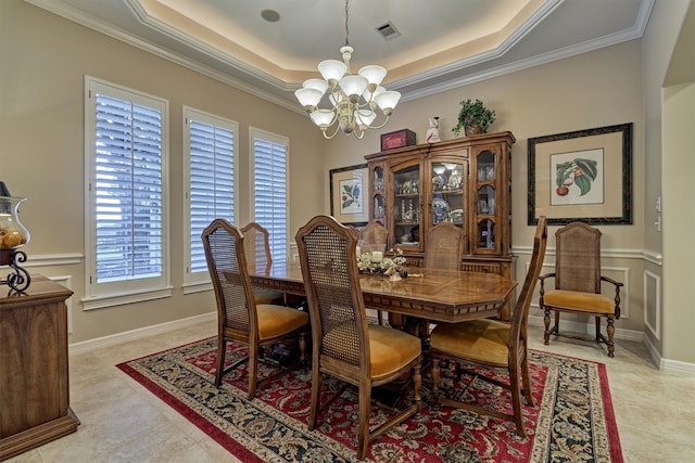 dining space featuring crown molding, a tray ceiling, light tile patterned floors, and a notable chandelier