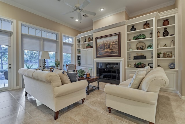 living room featuring ceiling fan, crown molding, and light tile patterned floors