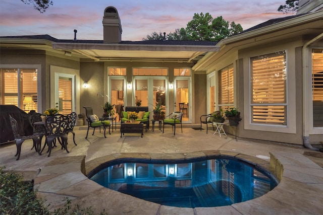 pool at dusk featuring a patio area