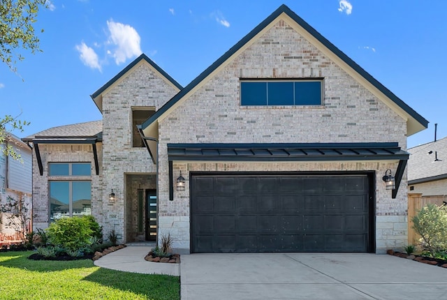 view of front of home with a garage and a front lawn