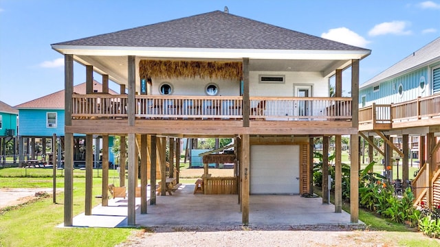 rear view of house with a wooden deck and a patio