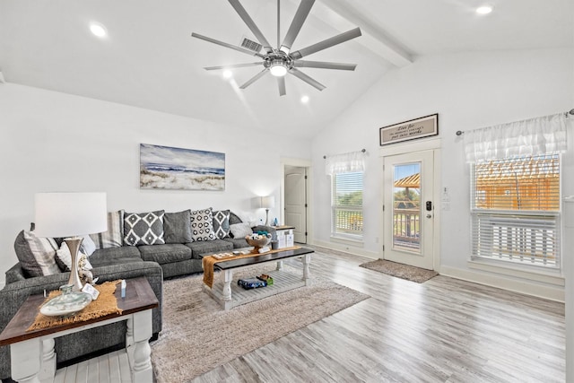 living room with beam ceiling, a ceiling fan, wood finished floors, high vaulted ceiling, and baseboards
