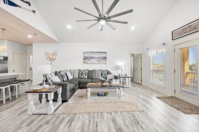 living room featuring high vaulted ceiling, light wood-style floors, ceiling fan, and recessed lighting