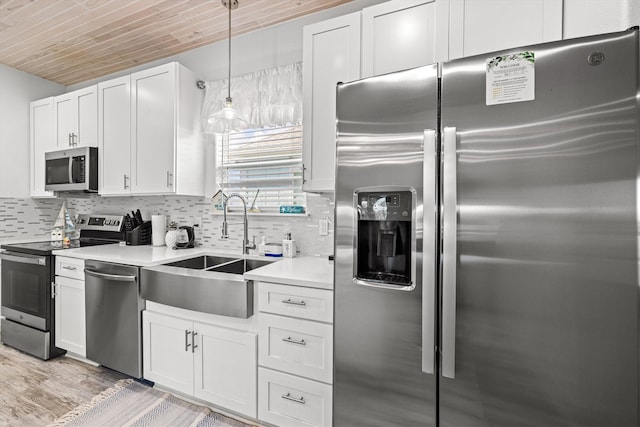 kitchen featuring appliances with stainless steel finishes, pendant lighting, sink, white cabinets, and wooden ceiling