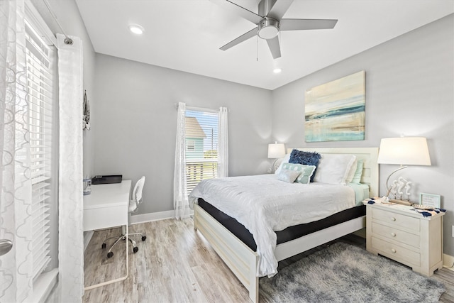 bedroom with ceiling fan and light hardwood / wood-style floors