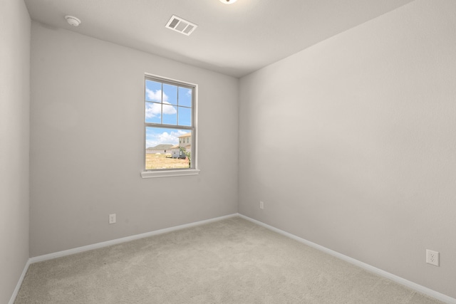 empty room featuring light colored carpet